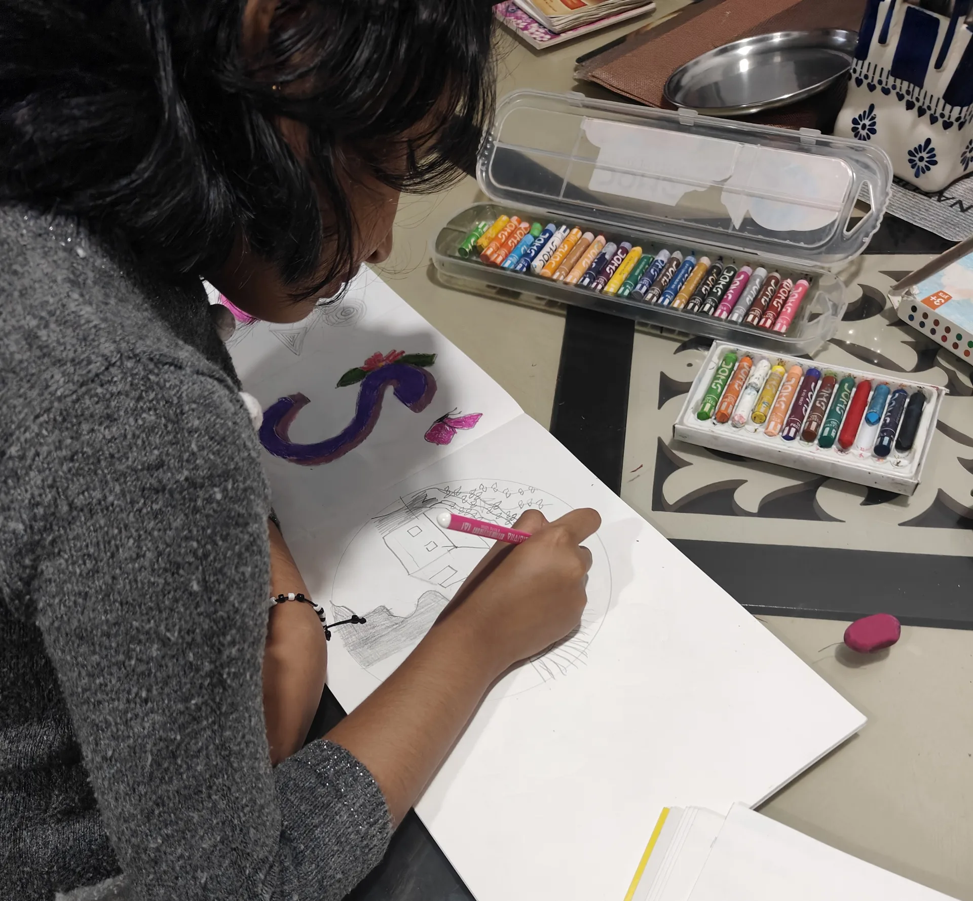 Children developing observation and patience through a guided art class